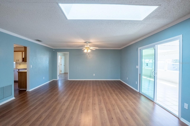 unfurnished living room with a skylight, wood finished floors, and visible vents