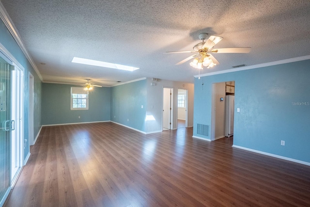 unfurnished room featuring visible vents, a skylight, crown molding, and dark wood-style flooring