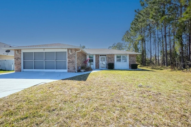 single story home with brick siding, an attached garage, concrete driveway, and a front yard