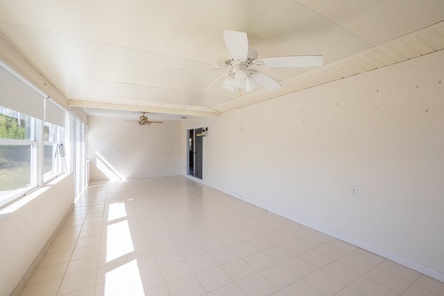 empty room with light tile patterned floors, baseboards, beam ceiling, and a ceiling fan