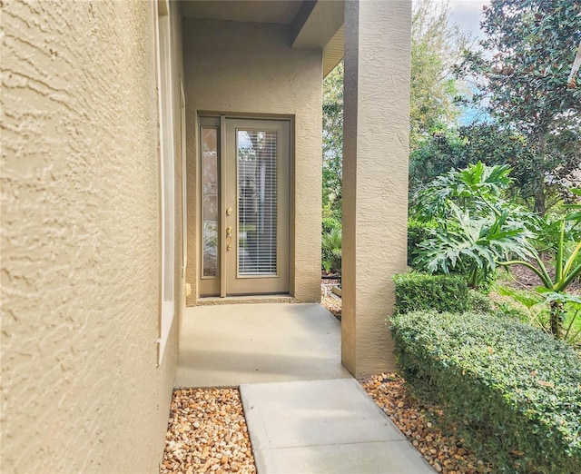 doorway to property with stucco siding