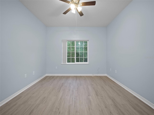 unfurnished room featuring ceiling fan, a textured ceiling, baseboards, and wood finished floors