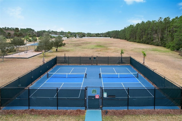 view of sport court featuring fence and a gate