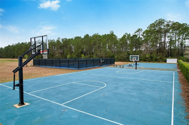 view of basketball court with community basketball court and fence