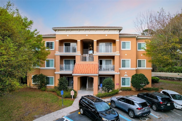 view of building exterior featuring uncovered parking