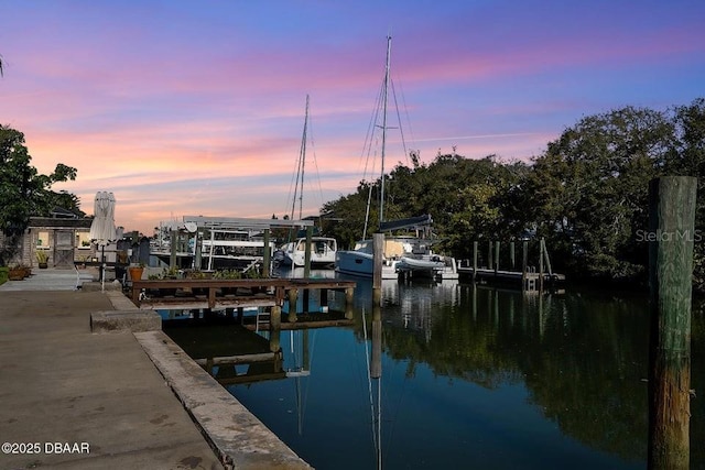 dock area with a water view and boat lift