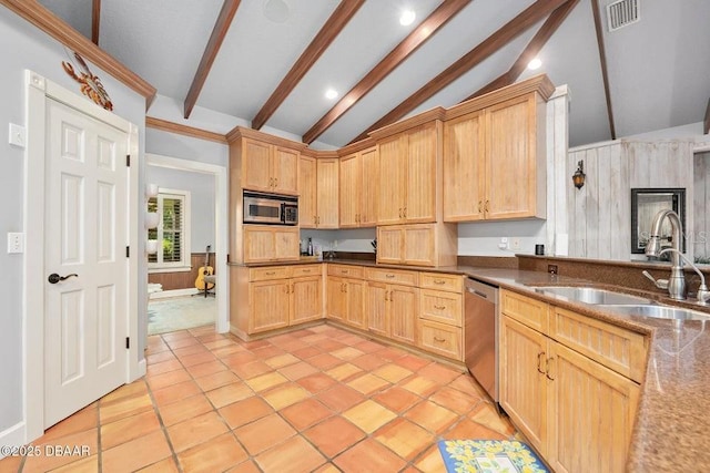 kitchen featuring appliances with stainless steel finishes, visible vents, a sink, and light brown cabinetry