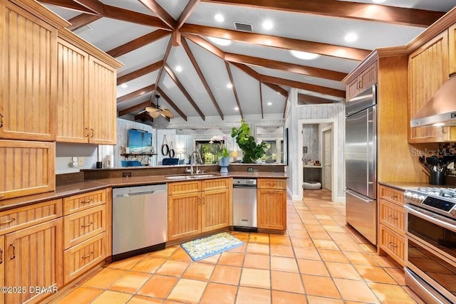 kitchen featuring visible vents, lofted ceiling with beams, appliances with stainless steel finishes, open floor plan, and a sink