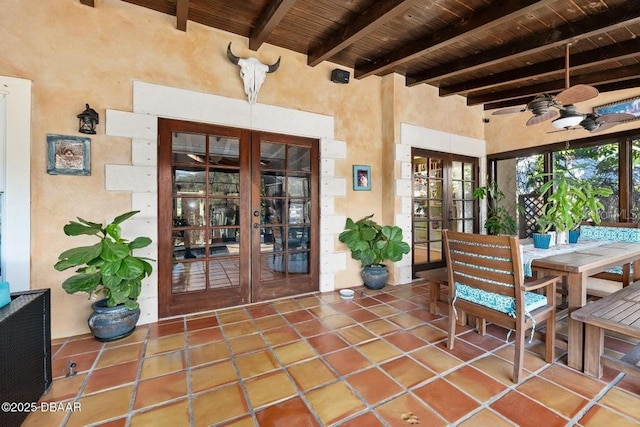 property entrance featuring french doors, a patio, and outdoor dining area