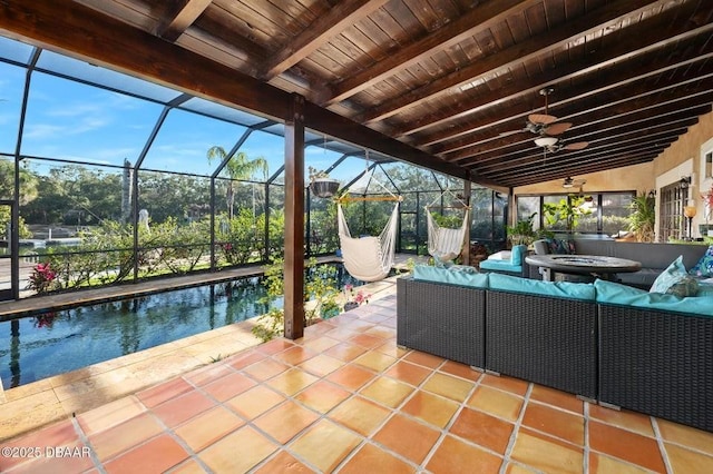 view of patio / terrace featuring outdoor lounge area, a lanai, a ceiling fan, and an outdoor pool