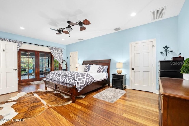 bedroom featuring access to exterior, visible vents, light wood finished floors, and french doors