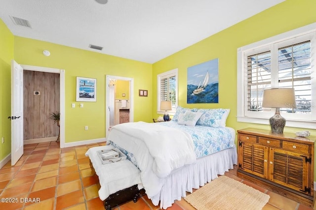 bedroom featuring light tile patterned floors, baseboards, and visible vents