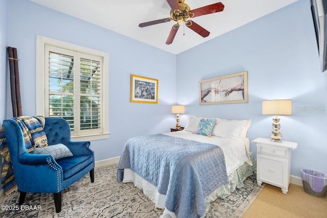 bedroom featuring light colored carpet, ceiling fan, and baseboards