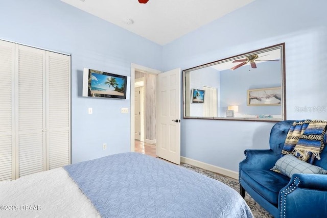 bedroom with a closet, baseboards, and a ceiling fan