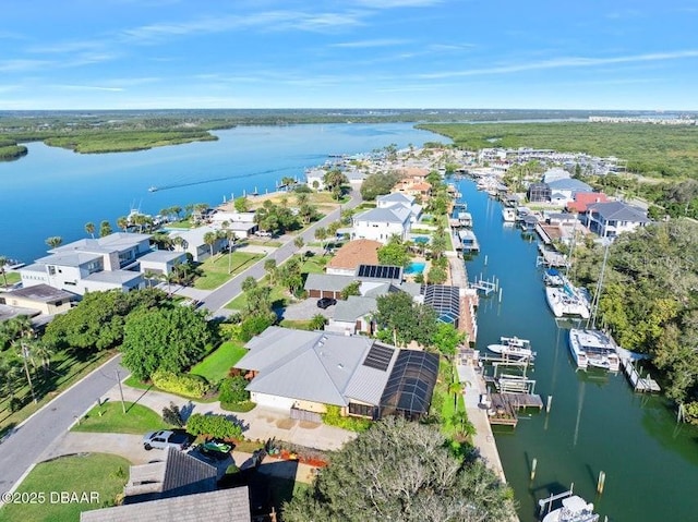 drone / aerial view with a water view and a residential view