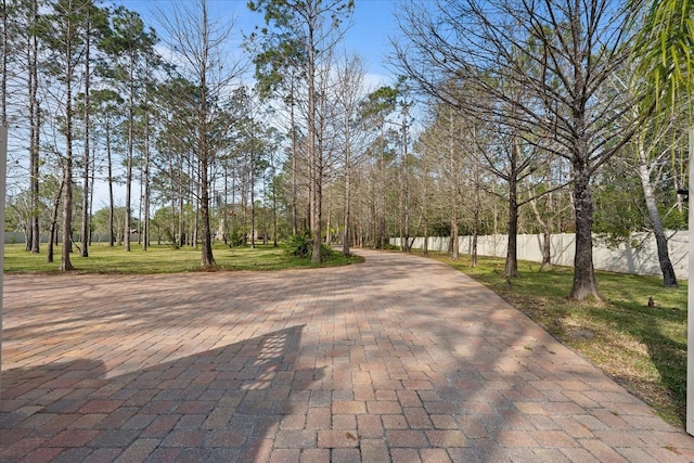 surrounding community with fence and a lawn