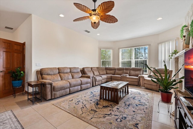 living area with light tile patterned floors, visible vents, and a ceiling fan