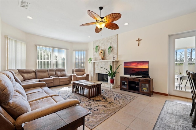 living room with light tile patterned floors, recessed lighting, visible vents, a ceiling fan, and a high end fireplace