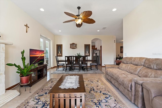 living room with arched walkways, light tile patterned flooring, ceiling fan, and recessed lighting