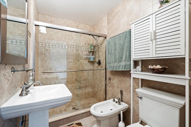 full bath with a bidet, toilet, a sink, tile walls, and a stall shower