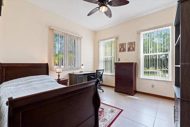 bedroom with ceiling fan, baseboards, and light tile patterned flooring