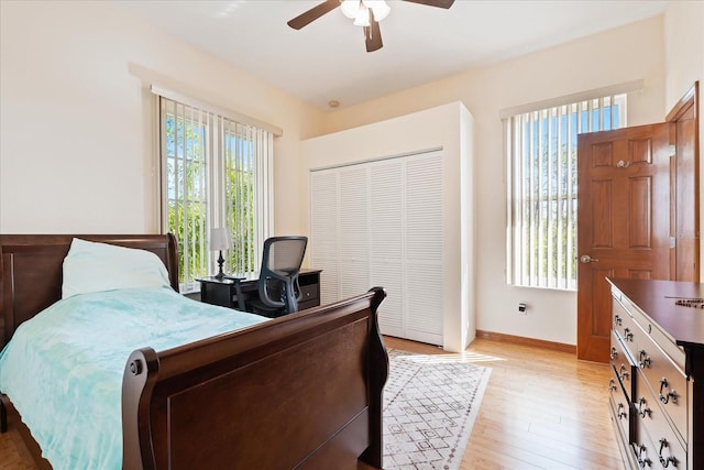 bedroom featuring a closet, baseboards, ceiling fan, and light wood finished floors