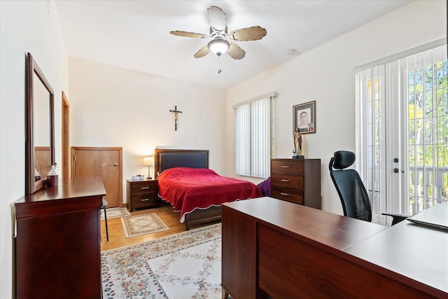 bedroom featuring access to exterior, ceiling fan, and wood finished floors