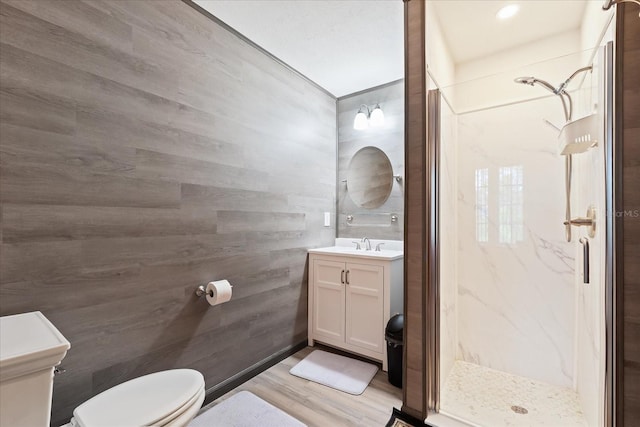 bathroom featuring a stall shower, vanity, and toilet