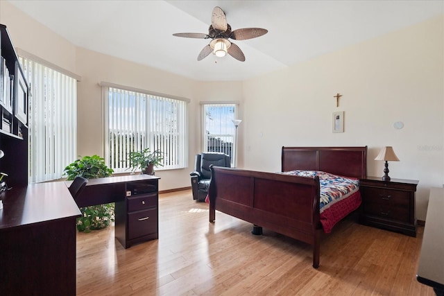 bedroom featuring light wood finished floors and baseboards