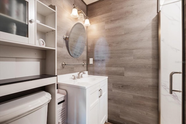 full bath featuring toilet, a shower stall, and vanity