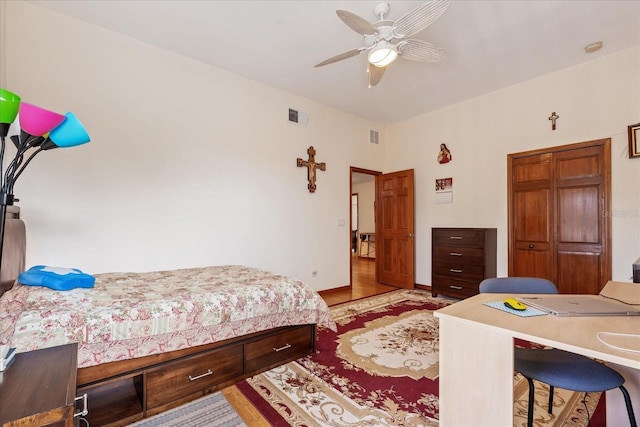 bedroom with light wood-type flooring, visible vents, and baseboards