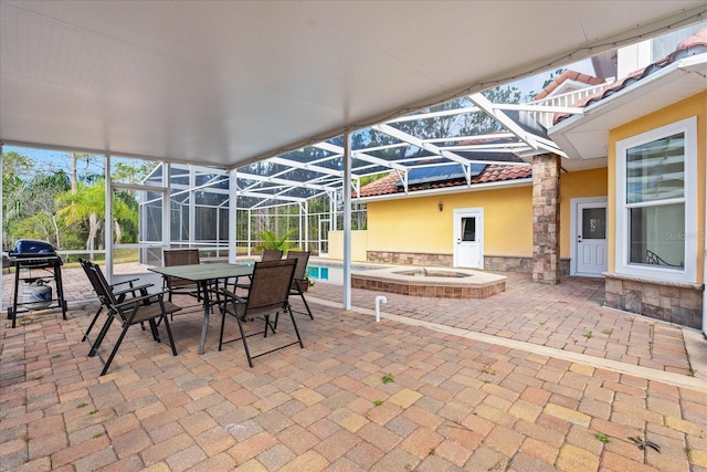 view of patio / terrace featuring a lanai, a jacuzzi, and an outdoor pool