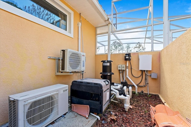 exterior details featuring ac unit and stucco siding