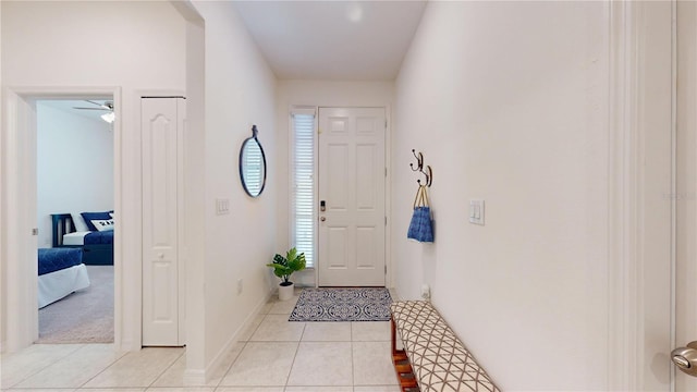 entryway featuring light tile patterned floors and baseboards