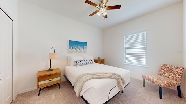 bedroom featuring light carpet, ceiling fan, and baseboards