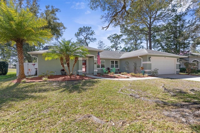 ranch-style home featuring a front yard, an attached garage, driveway, and stucco siding