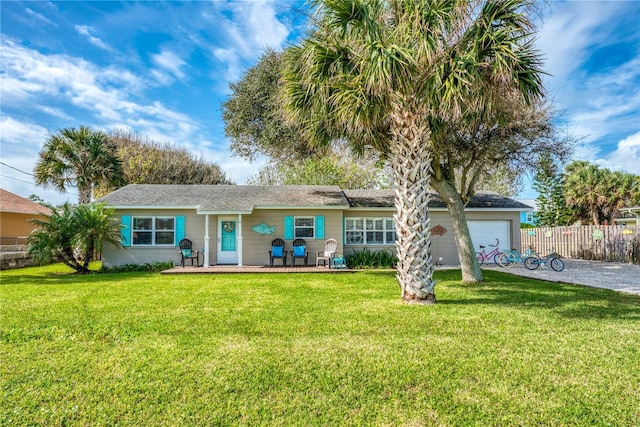 single story home featuring a garage, driveway, fence, and a front yard