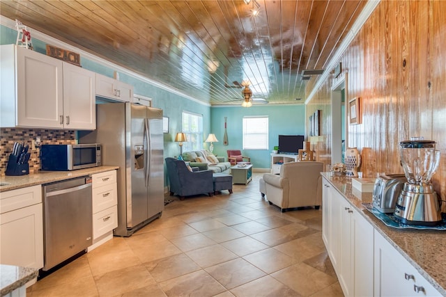 kitchen featuring wooden ceiling, white cabinetry, open floor plan, ornamental molding, and appliances with stainless steel finishes