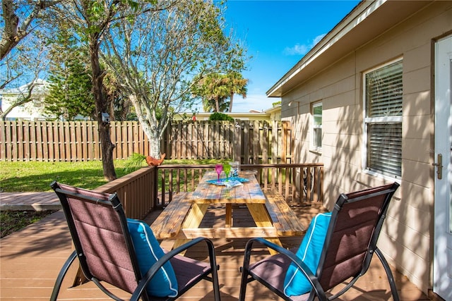 wooden terrace featuring fence and outdoor dining area