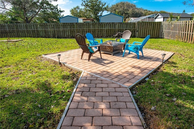 view of patio with a fenced backyard and a fire pit