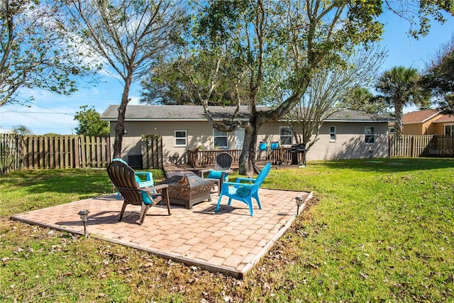 view of yard featuring a patio area, a fenced backyard, and a fire pit