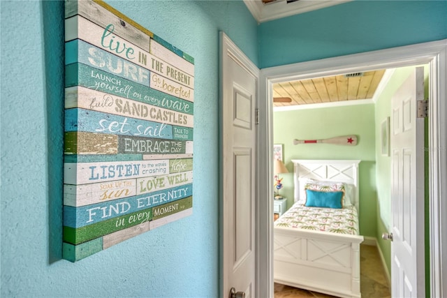 interior space with a textured wall and crown molding