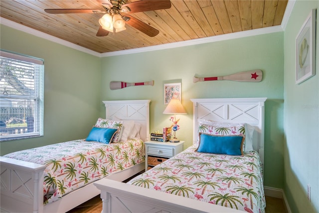 bedroom featuring wood ceiling, crown molding, baseboards, and ceiling fan