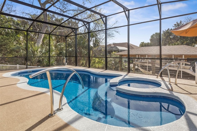 outdoor pool featuring glass enclosure, a patio, and an in ground hot tub