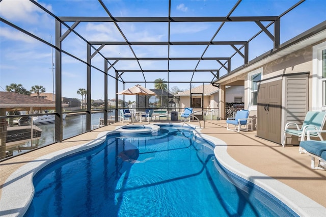 view of pool with a water view, glass enclosure, a pool with connected hot tub, and a patio area