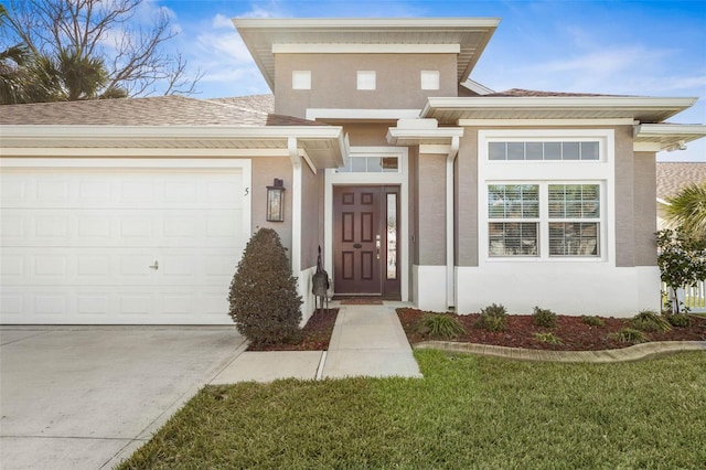 doorway to property with a garage, driveway, roof with shingles, and stucco siding