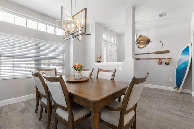 dining room with wood finished floors, visible vents, and a healthy amount of sunlight