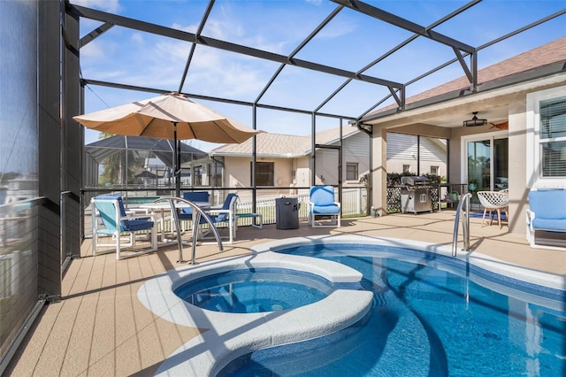 view of swimming pool with a pool with connected hot tub and glass enclosure