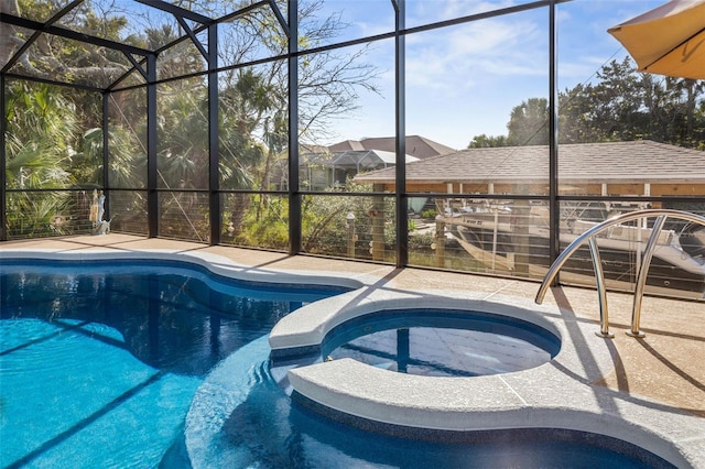 view of pool featuring a lanai, a patio area, and a pool with connected hot tub