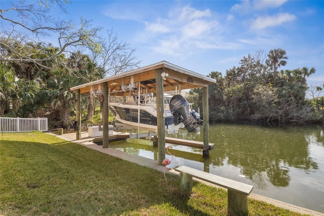 view of dock with a water view, a yard, boat lift, and fence